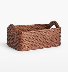 a brown basket with handles on a white background