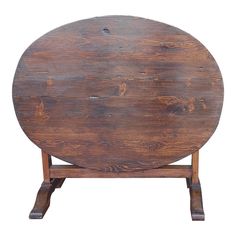 an old wooden table with two legs and a small round top on one leg, against a white background