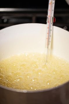 a thermometer sticking into a pot full of food that is being cooked in it