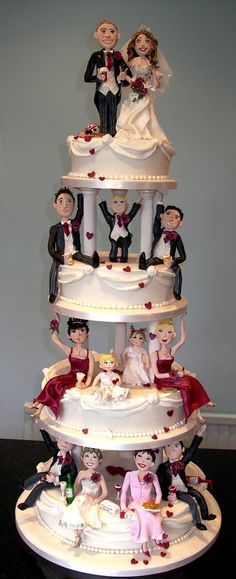 a wedding cake with many figurines on it's tiered display stand