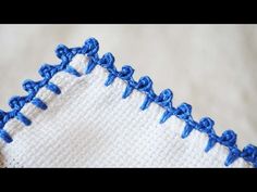 blue stitching on the side of a white piece of cloth