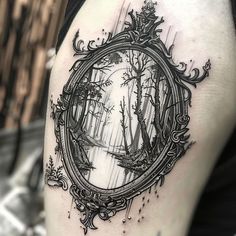 a black and white photo of a forest with a mirror on it's thigh