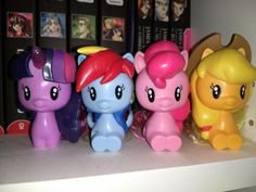 there are many little pony toys lined up on the shelf