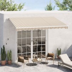 an outdoor patio with chairs, tables and a awning on the side of it