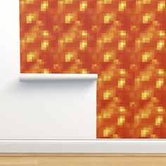 an orange and yellow wallpaper is next to a white door with a wooden floor