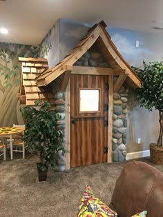 a small house made out of rocks and wood in a living room with a couch