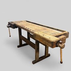 a bench made out of wooden planks sitting on top of a gray background with a hammer in it