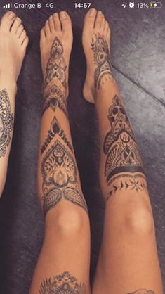 two people with tattoos on their legs