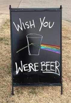 a sign that says wish you were beer with a rainbow in the cup on it