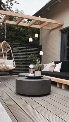 an outdoor living area with black furniture and white pillows