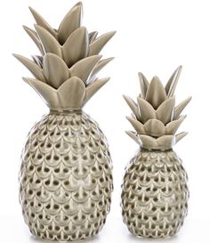 two ceramic pineapples sitting next to each other