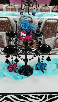 a table topped with lots of black and blue decorations