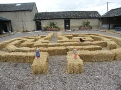 a hay maze with two scarecrows in it