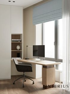 a desk with a computer on it in front of a window