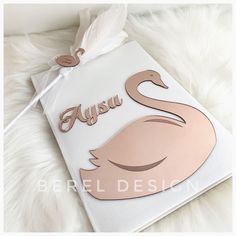 a card with a pink swan on it and the words ausu written in gold