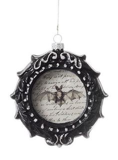 an ornament with a bat hanging from it's side on a white background