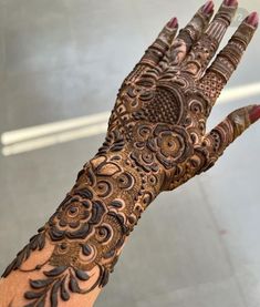 a woman's hand with hennap on it, showing the intricate design