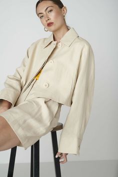 If you are looking for a truly unique jacket to wear formal and casual, then the June Jacket in Beige might be the perfect choice. The cropped jacket has a with a relaxed fit and voluminous sleeves with buttoned cuffs. It features tree functional large sized buttons in the front, a wide collar and side slit pockets. The June Jacket pairs well with our matching Bièl shorts, your favorite dresses and high waist pants. You can wear it as a blazer or jacket. The outer fabric is made from 100% dead stock linen and the inside is fully lined. The production is carried out by a family-owned business in Portugal.Size & FitFits true to size. Our model is 177cm (5 feet 9.7 inches) and wears size S. Materials & CareThe fabric of the June Jacket is made from 100% deadstock linen. The inside body lining Cropped Jacket Outfit Casual, Cropped Jacket Outfit, Outer Linen, Outfit Outer, Boss Woman, Unique Jackets, Voluminous Sleeves, High Waist Pants, Summer Jacket