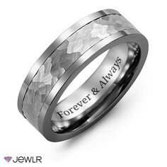 a wedding ring with an engraved message on the center and two rows of white gold inlays