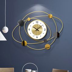 a clock that is hanging on the wall next to a dining room table and chairs