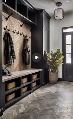 the entryway is decorated with black and white herringbones, wood flooring, and coat racks