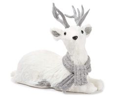 a white stuffed animal with antlers on it's head and scarf around its neck