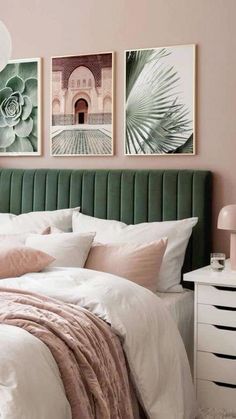 a bedroom with pink walls and green headboard, white bedding, two pictures on the wall