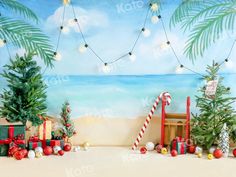 christmas decorations on the beach with palm trees and presents in front of a wall mural