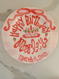 a plate with the words happy birthday mollies on it and a cake in the middle