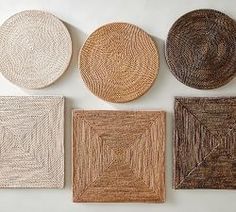 six woven coasters are arranged on a white surface, each with different shapes and sizes