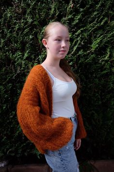 This hand-knitted orange cardigan combines the luxurious softness of mohair, alpaca, and wool for ultimate warmth and comfort. Featuring long sleeves and a classic button closure, this timeless cardigan is the perfect piece for fall. The blend of high-quality natural fibers ensures softness, durability, and insulation, making it ideal for layering in cooler weather. Designed in a sophisticated, classic style, this cardigan is versatile enough to pair with both casual and formal outfits. The neutral gray color adds elegance, while the fine craftsmanship ensures you get a unique, hand-made garment that is both stylish and functional. Whether you're heading out for a crisp fall walk or layering up for the office, this cardigan will keep you warm in style. Classic Fall Style, Orange Cardigan, Wool Cardigan, Formal Outfit, Jumpers And Cardigans, Cardigans For Women, Sweaters & Cardigans, Sweater Outfits, Hand Knitting