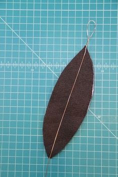 a piece of fabric with a wire attached to it sitting on top of a cutting board