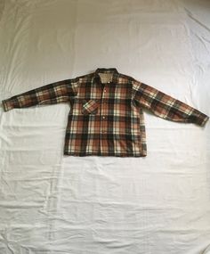 "vintage 1960s plaid board shirt 65% acrylic, 35% wool loop collar button up left breast pocket acrylic yoke hem straight tail brown, white, and black good vintage condition, light wear-light pilling left elbow hole mended (by me) w/underside patch,  tiny paint drop below pocket (see photos) light weight weave no size tag, most like med/large, see below measures, lying flat, shoulder-17\" chest-20 1/2\" sleeve-24\" length-27\"     We do not offer returns or refunds unless something is grossly misrepresented. Please contact us within 2 business days of receiving to discuss any possible returns for this reason. We do not offer refunds for your shipping fees. Please feel free to contact us with any questions you may have about an item prior to purchase and we will gladly answer them." Brown Collared Flannel Shirt With Buttons, Brown Winter Flannel Shirt With Buttons, Brown Winter Flannel Shirt, Winter Brown Flannel Shirt, Retro Collared Flannel Shirt With Pockets, Retro Collared Flannel Shirt For Winter, Brown Flannel Shirt With Button Closure For Winter, Brown Winter Flannel Shirt With Button Closure, Winter Brown Flannel Shirt With Button Closure