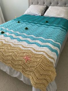 a crocheted bedspread on a bed in a bedroom