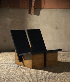 two wooden benches sitting on top of a rug