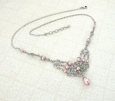 "To make this Victorian inspired necklace, I paired soft, powder pink Swarovski crystal pearls and beads with lovely, antique silver filigree with an elegant floral motif. I embellished the filigree with glinting Swarovski crystal stones and dressed the pearls in antique silver floral bead caps and adornments to enhance the vintage feel. The crystal beads are Swarovski's Antique Pink hue - an elegant dusty pink that to me, has a romantic Old-World feel. ------------------------------------------ Elegant Pink Necklace With Intricate Design, Pink Necklaces With Intricate Design For Gift, Elegant Pink Beaded Bridal Necklace, Pink Pearl Wedding, Victorian Wedding Jewelry, Pearl Wedding Necklace, Pink Pearl Earrings, Pink Victorian, Victorian Necklace