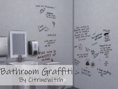 a bathroom with writing on the wall next to two sinks and a mirror in front of it