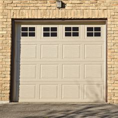 a garage door is shown in front of a brick building