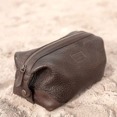 The Lucchese Dopp Kit is a perfect match to the overnight duffle or rolling duffle. An extra-wide zippered opening makes it easy to stash your essentials. Three interior pockets help keep small items organized on the road. A snap closure at both ends doubles as a handle. Features: 10" L x 5.5 " W x 6.5" H Constructed from full-grain pebbled cowhide leather Smooth leather trim and elbows contrast with the pebbled leather for interest and added strength at stress points Extra-wide opening for easy Brown Pouch With Zipper Closure For Travel, Practical Travel Pouch With Zipper Closure, Practical Travel Pouch With Zipper, Functional Travel Bag With Zipper Closure For Storage, Travel Pouch With Zipper Closure, Travel Case With Zipper Pocket Shaped As Pouch, Brown Bags With Luggage Sleeve For Storage, Travel Case With Zipper Pocket, Leather Travel Pouch With Zipper Closure