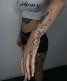 a woman with tattoos on her arm and hand