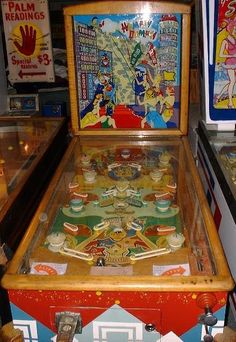 an old fashioned pinball machine sitting on top of a table