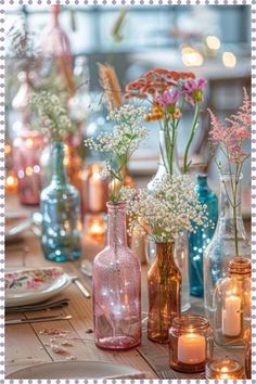 there are many vases with flowers in them on the table