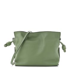 This is an authentic LOEWE Calfskin Mini Flamenco Knot Bag in Avocado.This chic and lovely tote is crafted of luxuriously soft calfskin leather in green. This shoulder bag features green leather cinch cords, an optional shoulder strap, and gold hardware. The top opens to a brown suede fabric interior. Luxury Green Bag With Rolled Handles, Luxury Green Bags With Rolled Handles, Modern Green Shoulder Bag With Smooth Grain, Green Leather Pouch Shoulder Bag, Green Leather Shoulder Bag With Leather Handles, Green Top Handle Bag In Soft Leather, Luxury Green Bag With Smooth Grain, Designer Green Leather Shoulder Bag, Green Soft Leather Shoulder Bag