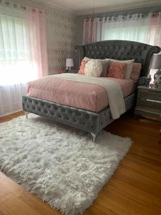 a bedroom with a bed, rug and window