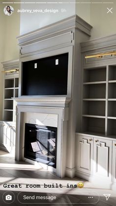 an empty room with built - in bookshelves and a tv above the fireplace