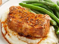 meat and mashed potatoes on a plate with green beans