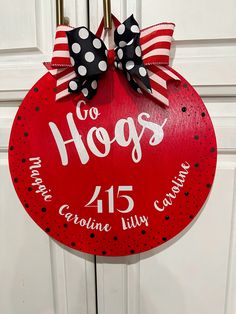 a red door hanger with black and white polka dots on it that says go hogs