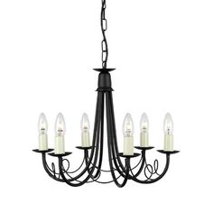 a black chandelier with six candles hanging from the bottom and one light on top