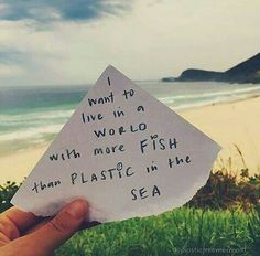 someone holding up a piece of paper that says i want to live in a world with more fish than plastic in the sea