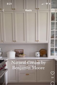 the kitchen has all white cabinets and silver appliances on it's counter tops, along with words that read natural cream by bojam moore